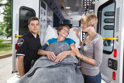 senior women being taken on ambulance